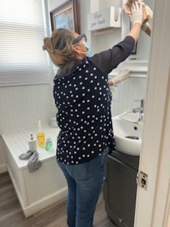 Crew member detailing a bathroom